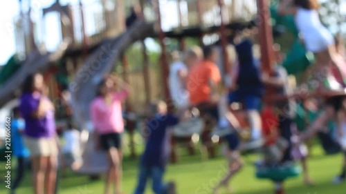 Kids playing on a busy playground park. 