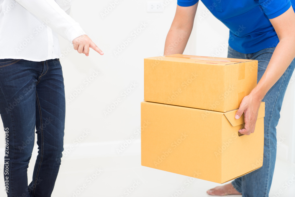 Woman receiving package from delivery man - put it down Woman receiving package from delivery man - put it down