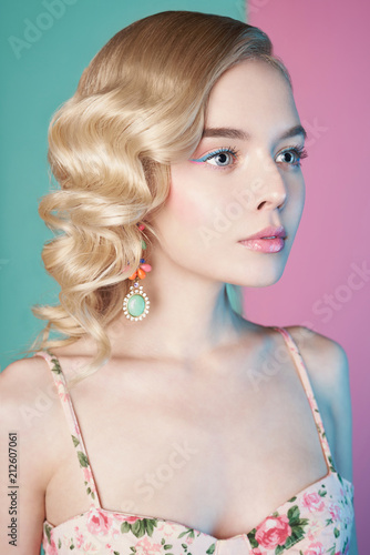 Blonde woman with color makup on colorful background