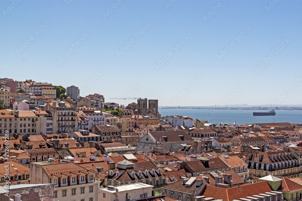The view of the city from view point. The roofs of the houses and the river Tagus. Lisbon, Portugal.