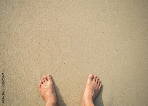 woman barefoot standing at a beach