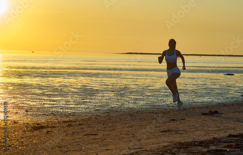 girl running by the sea on the beach