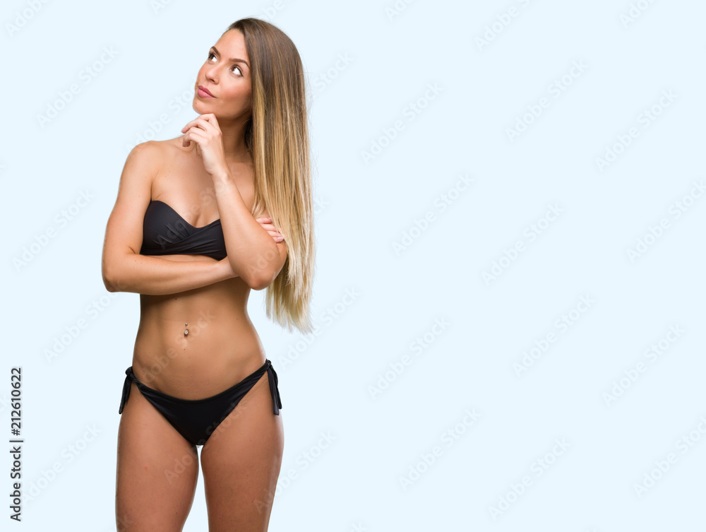 Obraz premium Beautiful young woman wearing black bikini serious face thinking about question, very confused idea