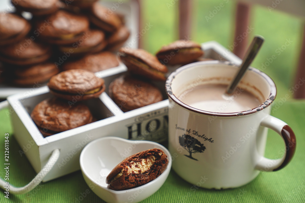 Fudge brownie cookies with penut and cheese filling with cacao on the mug Fudge brownie cookies with penut and cheese filling with cacao on the mug