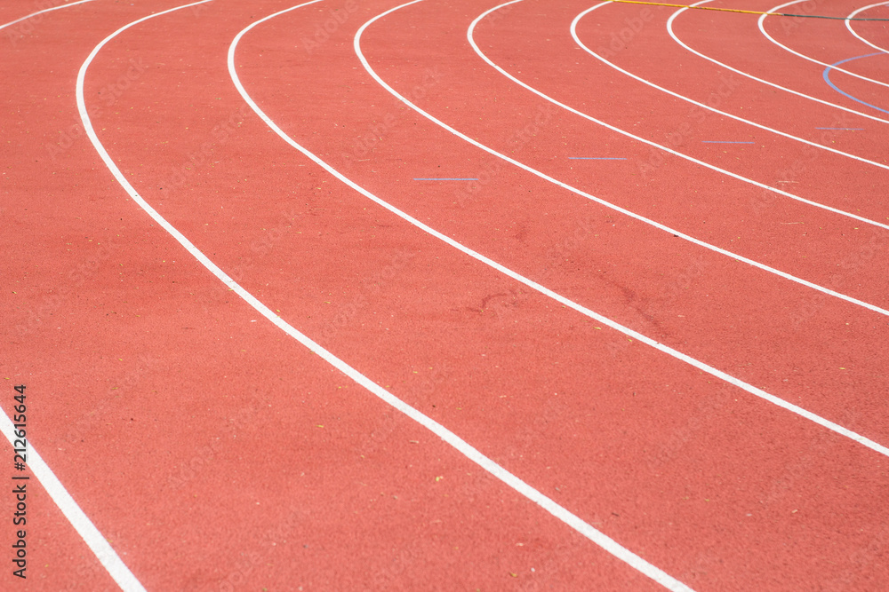 All-weather running track , orange and white lanes for running training All-weather running track , orange and white lanes for running training