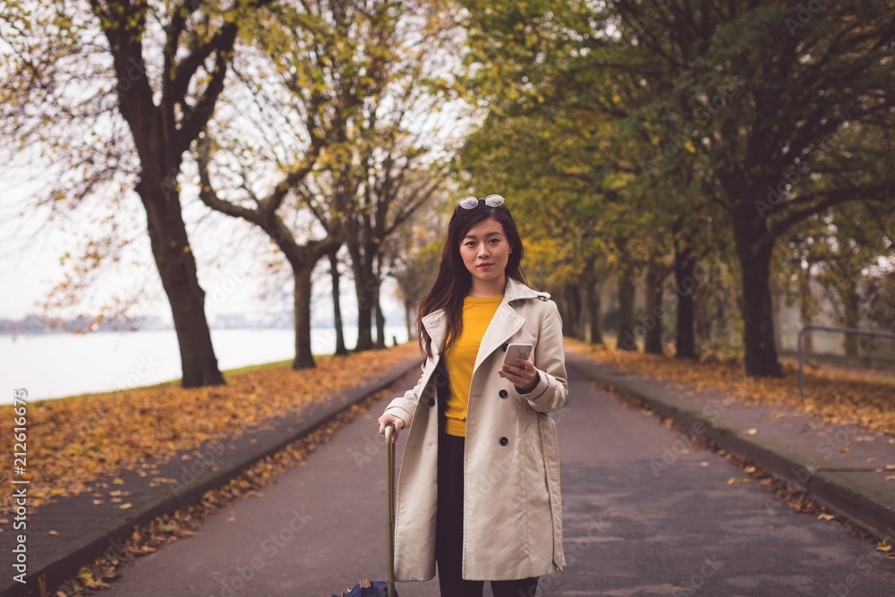 Businesswoman with mobile phone standing on street Businesswoman with mobile phone standing on street