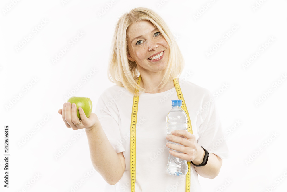 Beautiful young woman with a bottle of water in hands smiling, isolated on white background Beautiful young woman with a bottle of water in hands smiling, isolated on white background