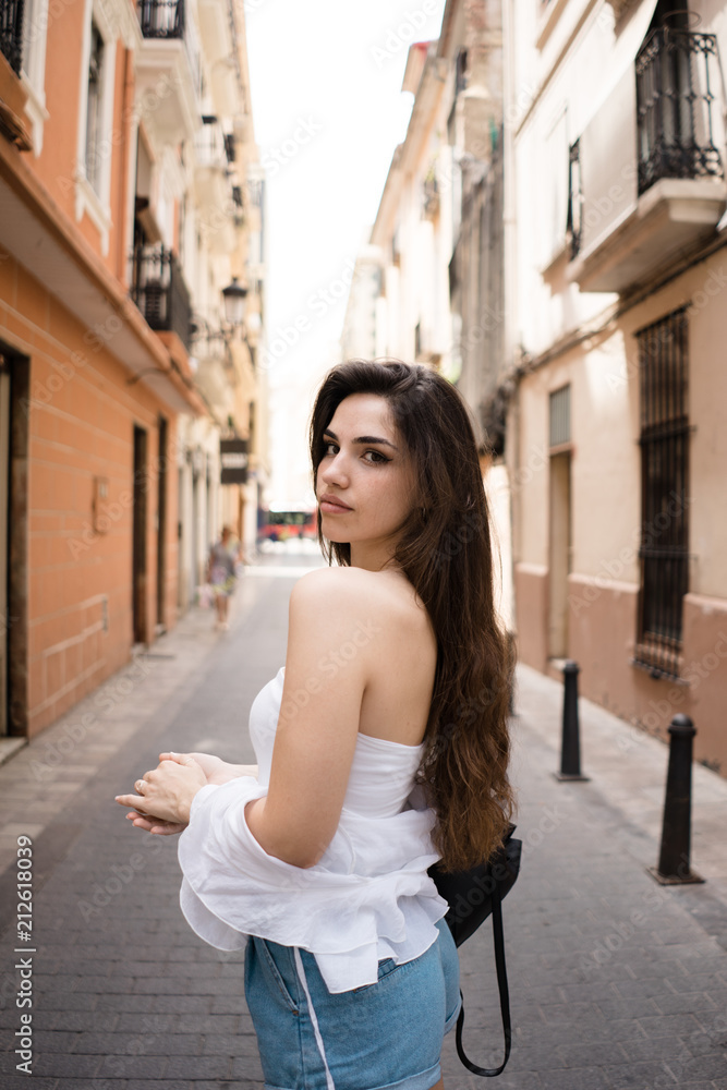 Gorgeous female standing on city alley