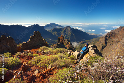 Resting man watching a landscape above the crater Caldera de Taburiente, Island of La Palma, Canary Islands, Spain photo