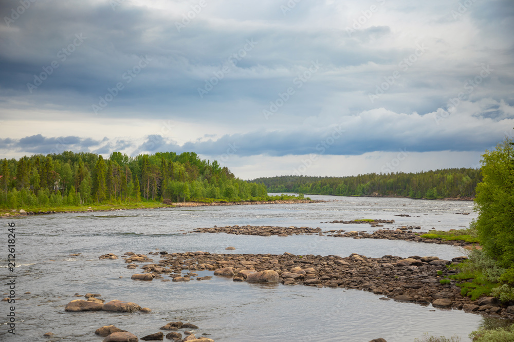 Katkasuvanto river is border between Finland and Sweden and dramatic sky
