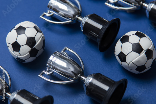 Soccer ball with a silver winning trophy photo