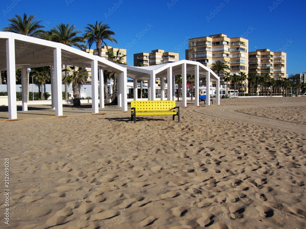 beach with yellow bench