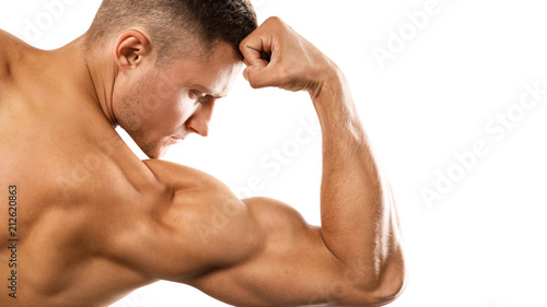 Young muscular man showing his bicep photo