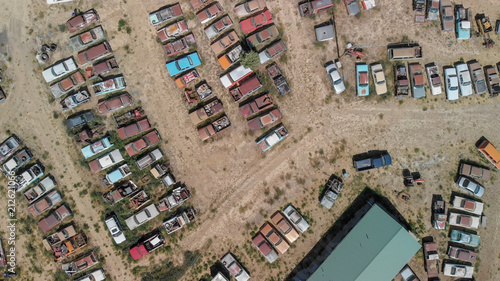Overhead view of old cars gathered in a countryside parking
