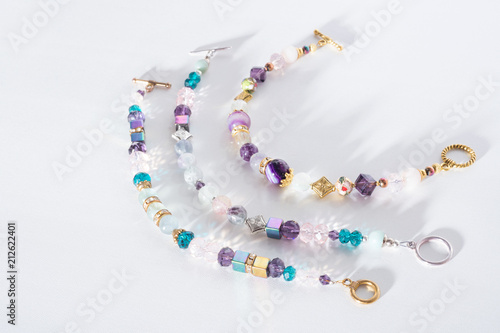 gold jewerly braslete with semiprecious at white background