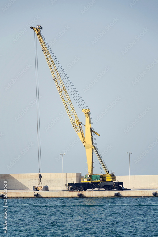 Empty shipping harbor with crane, freight digitalization, transportation efficiency concept Empty shipping harbor with crane, freight digitalization, transportation efficiency concept