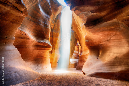 Upper Antelope Canyon with light rays filtering through sand dust