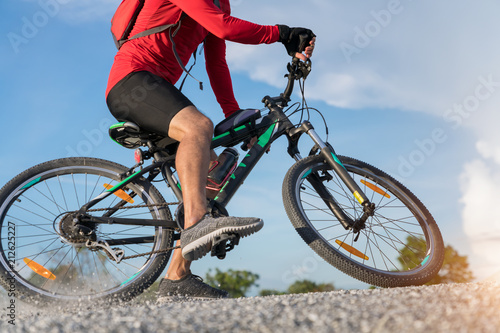 cyclist man riding a mountain bike up a hill, extreme sport mountain biker