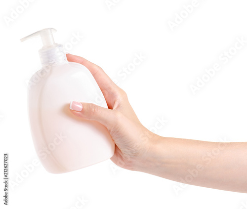 White soap bottle with dispenser in hand on white background isolation