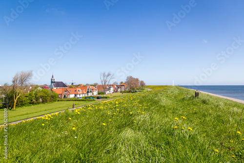 Panorama Village Oudeschild with Martinus church, windmill  and trraditional gable  houses on the Wadden island Texel in the Netherlands photo