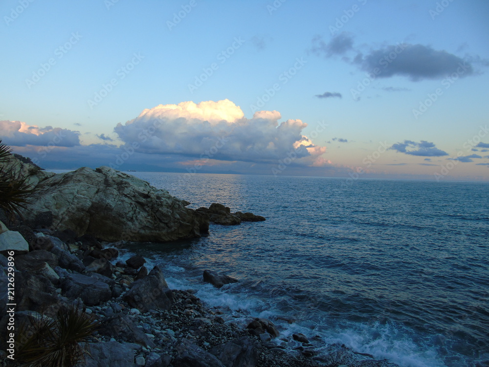 An amazing caption of a beautiful blue sea, small waves and a hidden sunset over the horizzon in sumer days An amazing caption of a beautiful blue sea, small waves and a hidden sunset over the horizzon in sumer days