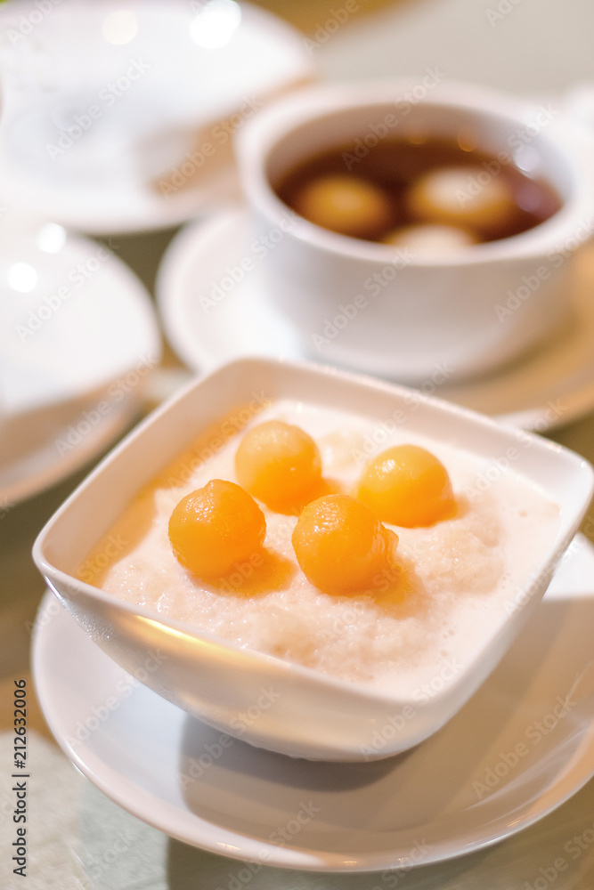 Asian dessert Sakhu in coconut milk with Cantaloupe ball topping Asian dessert Sakhu in coconut milk with Cantaloupe ball topping