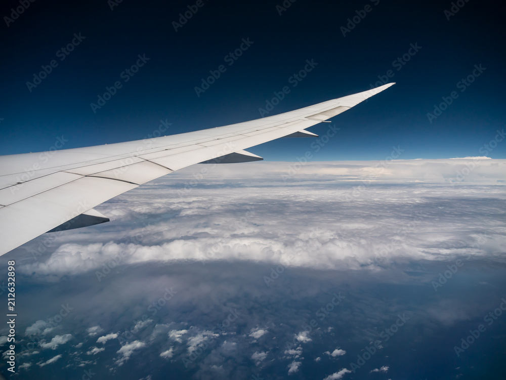 View from airplane window with blue sky and white clouds, background for travel holiday trip, Aircraft on the sky. View from airplane window with blue sky and white clouds, background for travel holiday trip, Aircraft on the sky.