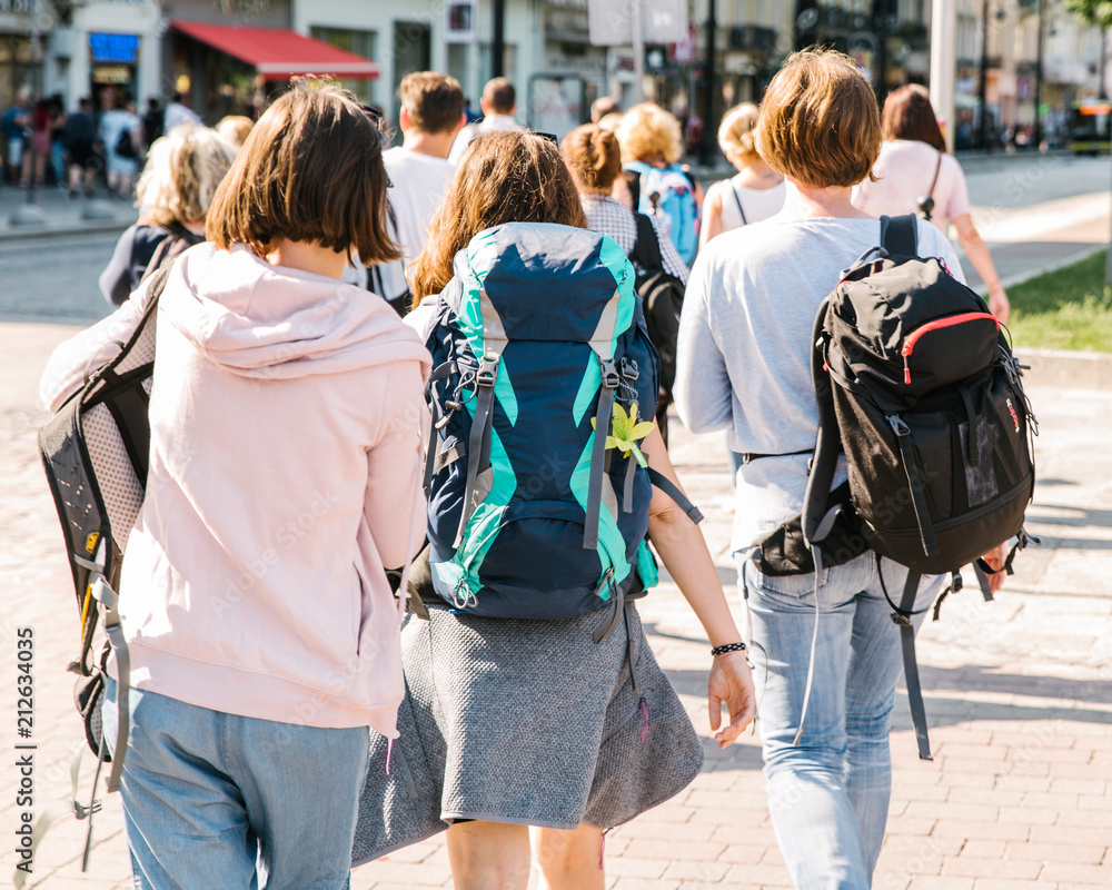 three young adult women walking by city streets. hikers in city three young adult women walking by city streets. hikers in city