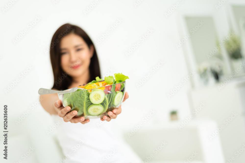 Asian woman holding healthy salad bowl. Asian woman holding healthy salad bowl.