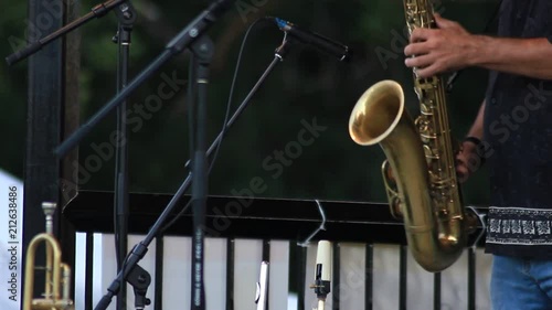 Man jamming out on a saxophone, during a summer time outdoor concert. photo