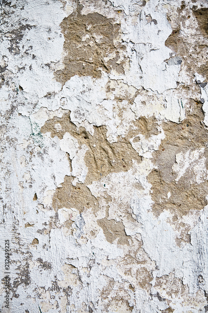 White old wall with cracked plaster. White old wall with cracked plaster.