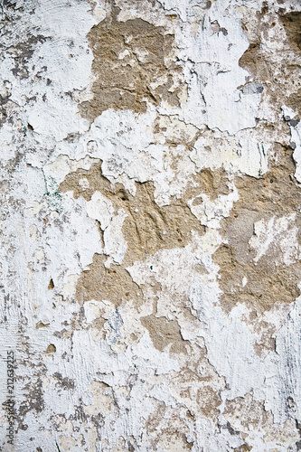 White old wall with cracked plaster.
