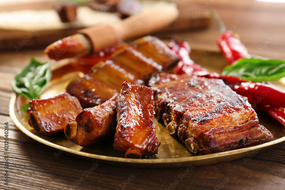 Plate with delicious grilled ribs on table Plate with delicious grilled ribs on table