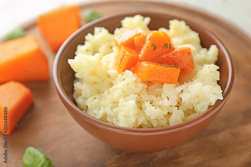 Bowl with delicious pumpkin risotto on table, closeup Bowl with delicious pumpkin risotto on table, closeup