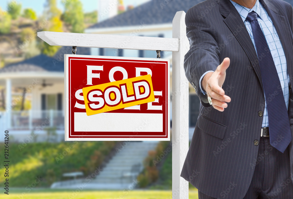 Φωτογραφία Male Agent Reaching for Hand Shake in Front of Sold For Sale Sign and House