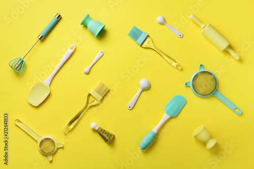 Turquoise cooking utensils on yellow background. Food ingredients. Cooking cakes and baking bread concept. Copy space. Top view. Flat lay