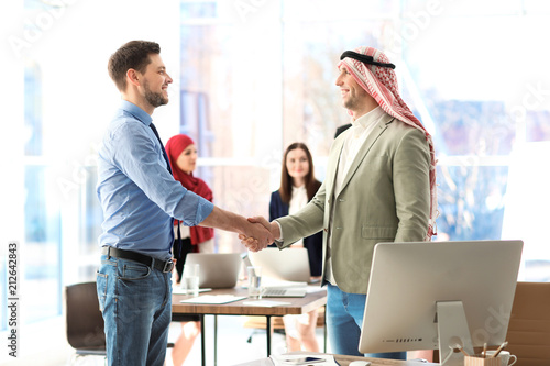 Muslim businessman shaking ...