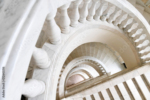 White marble spiral staircase and handrail