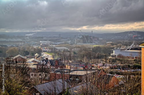 View over the town of Rotherham, including Rotherham United's New York Stadium, very industrial and urban under stormy grey sky photo