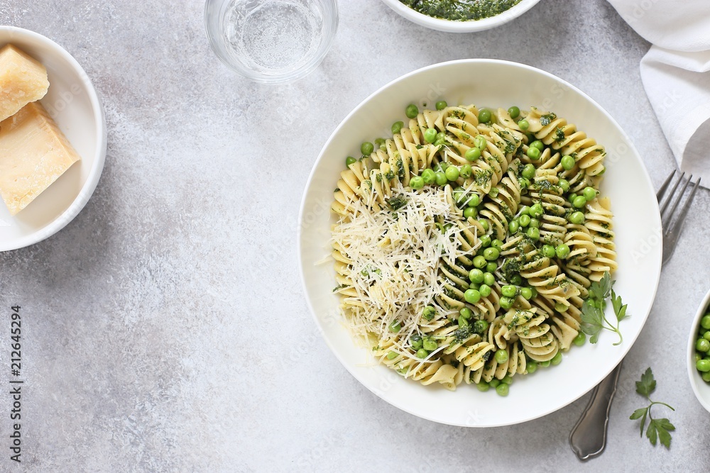 Pasta with pesto, green pea and parmesan. Overhead view, copy space