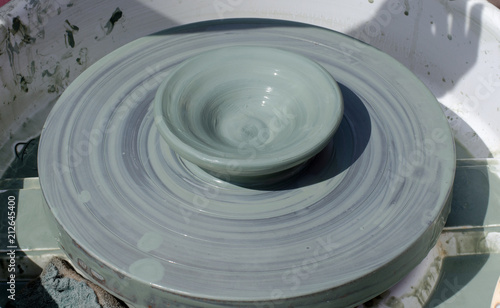 A Cup of blue clay on a Potter's wheel. Close up