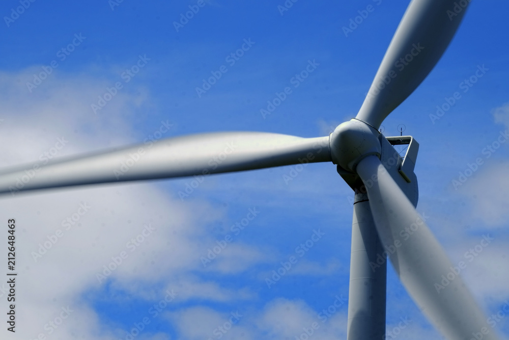 Windmill Producing Electricity with Blue Sky and Clouds Windmill Producing Electricity with Blue Sky and Clouds
