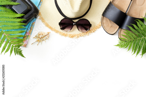 Tropacal vacation pattern. Straw beach sunhat, sun glasses, beach slaps, leaf of fern on white background. Top view with copy space. Summer.