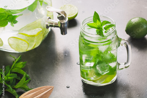 Mojito cocktail in mason jar with on black stone table. Copy space for text.