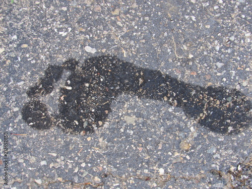 A wet footprint outside on the concrete 