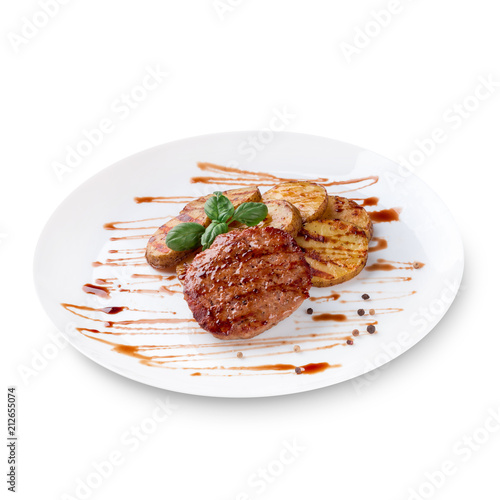 Grilled steak, baked potatoes, green basil and sauce on white plate