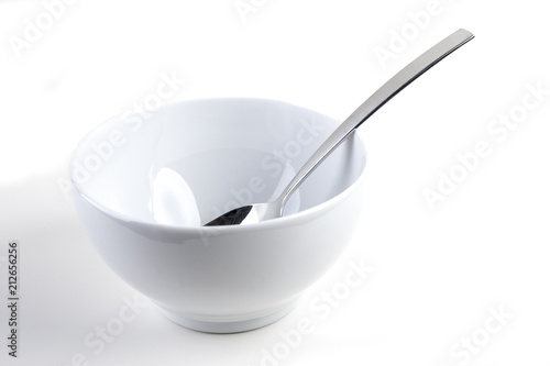 Cereal bowl with silver spoon on white background