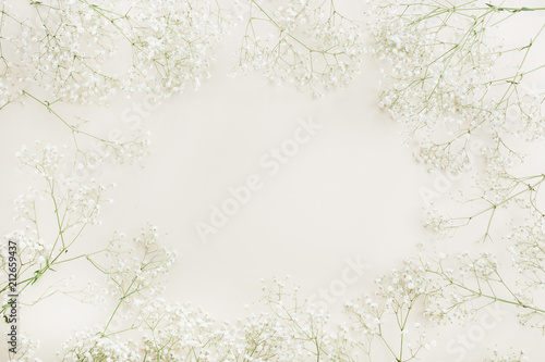 Frame of white gypsophila flower bouquet pattern. Flat lay, top view festive mock up background.