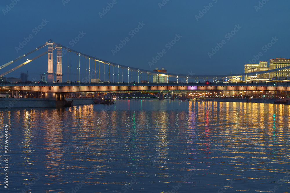 Brightly illuminated bridge at the sunset in Moscow