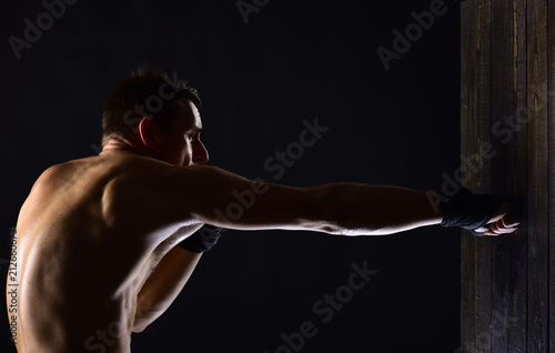 energy. energy and success in sport of muscular man. energy training of man boxer or fighter in gym. energy of man hitting wall with punch. young and energetic. photo